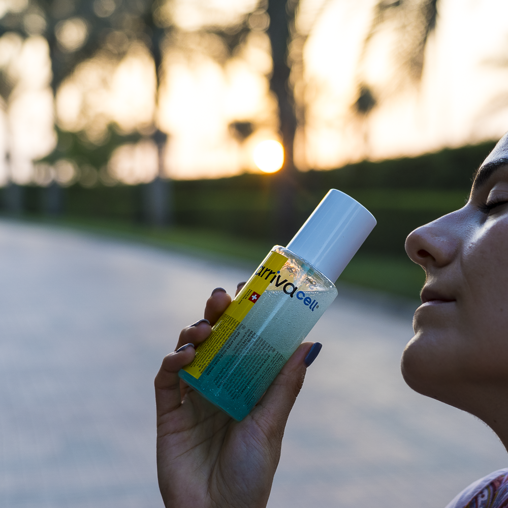 gril posing in sunset with after sun spray