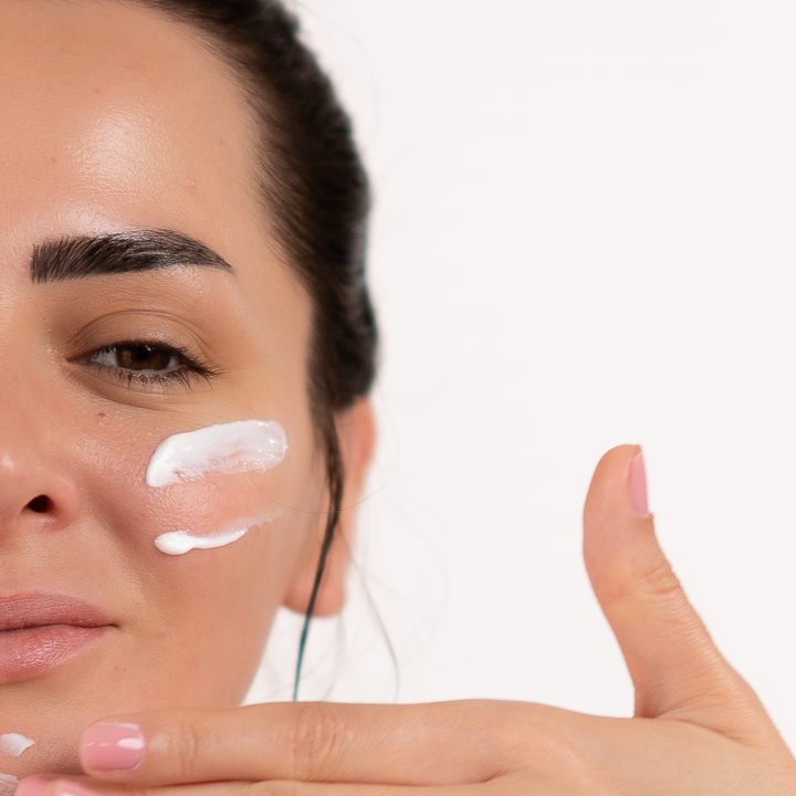 girl with sun cream on her face close up
