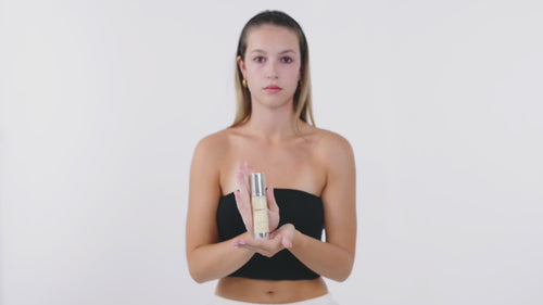 girl presenting the moisturizing fluid and showing how to use it